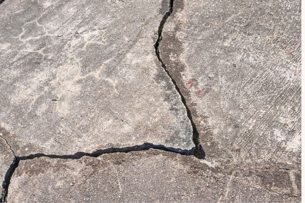 Cracked concrete garage floor showing various crack types