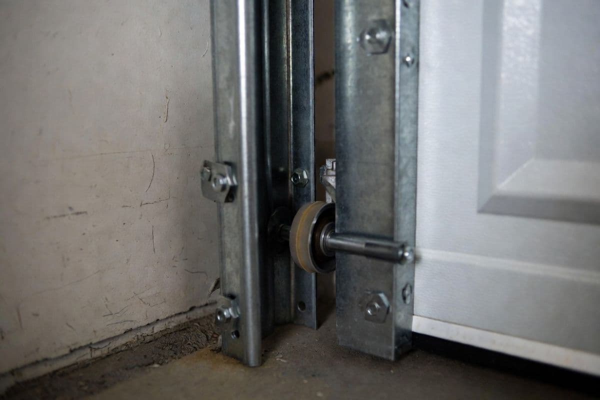 Garage door roller displaced from vertical side track showing off-track condition